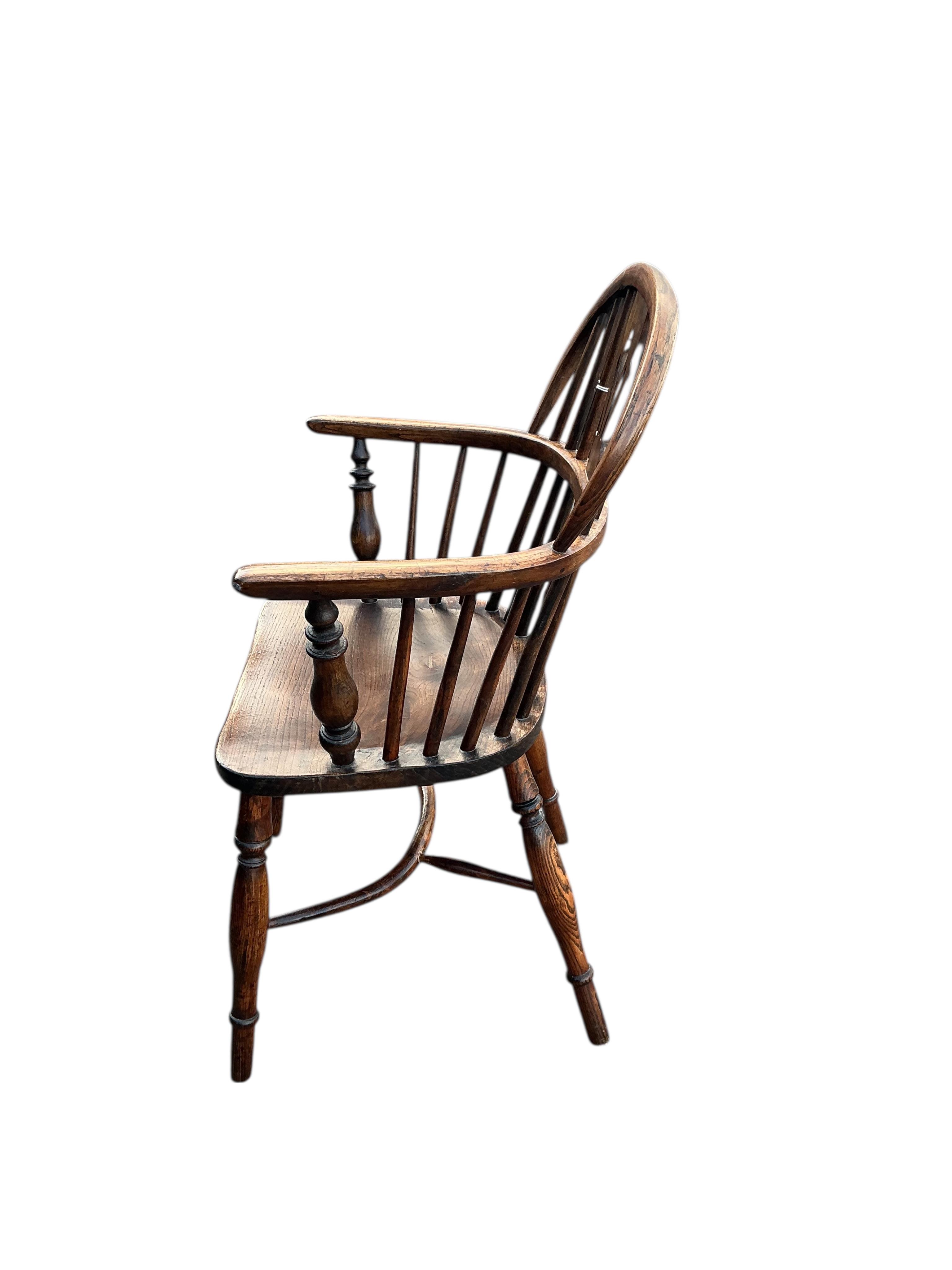 A 19th century Windsor ash and elm elbow chair with crinoline stretcher, width 57cm, depth 38cm, height 91cm